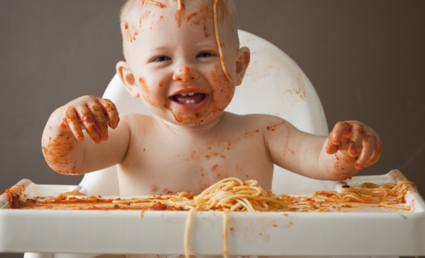 Baby covered in spaghetti