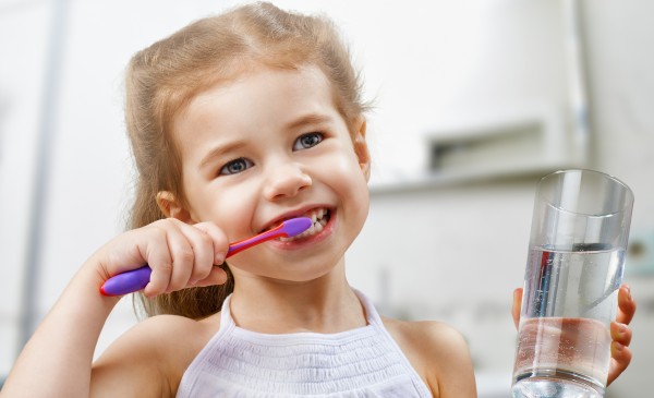 little girl brushing teeth