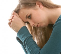 teenage depression - teen woman sitting thinking